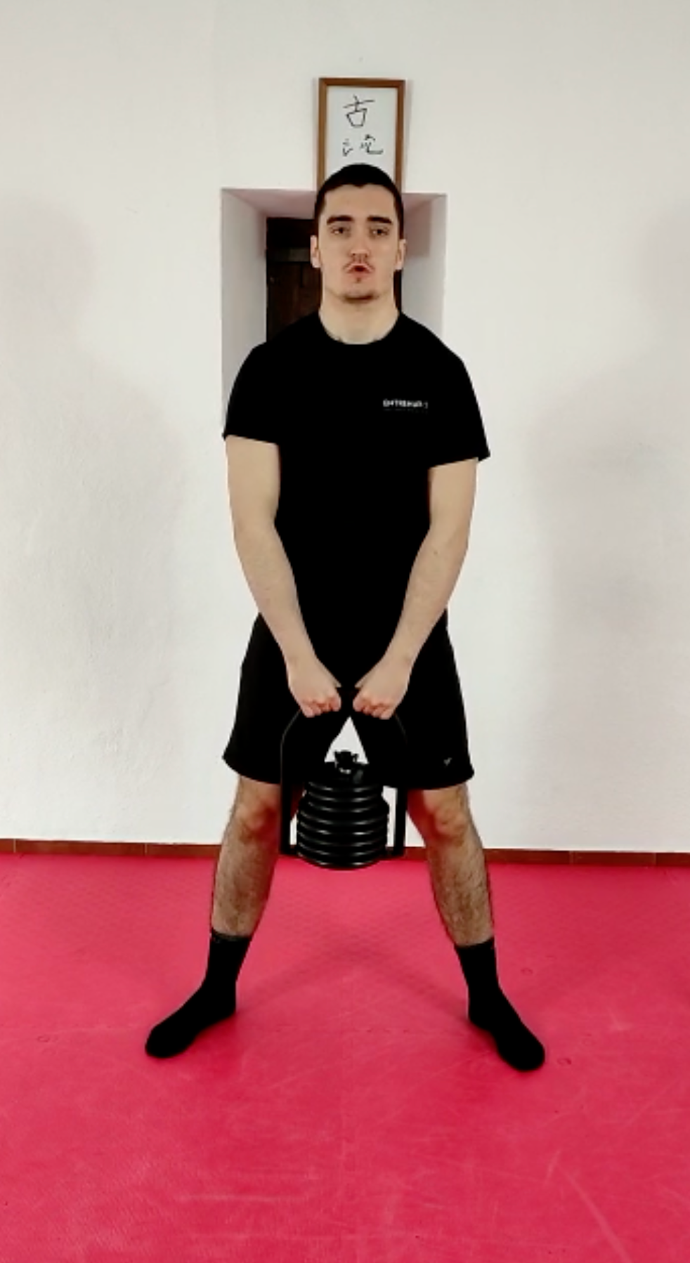 Standing kettlebell hold position